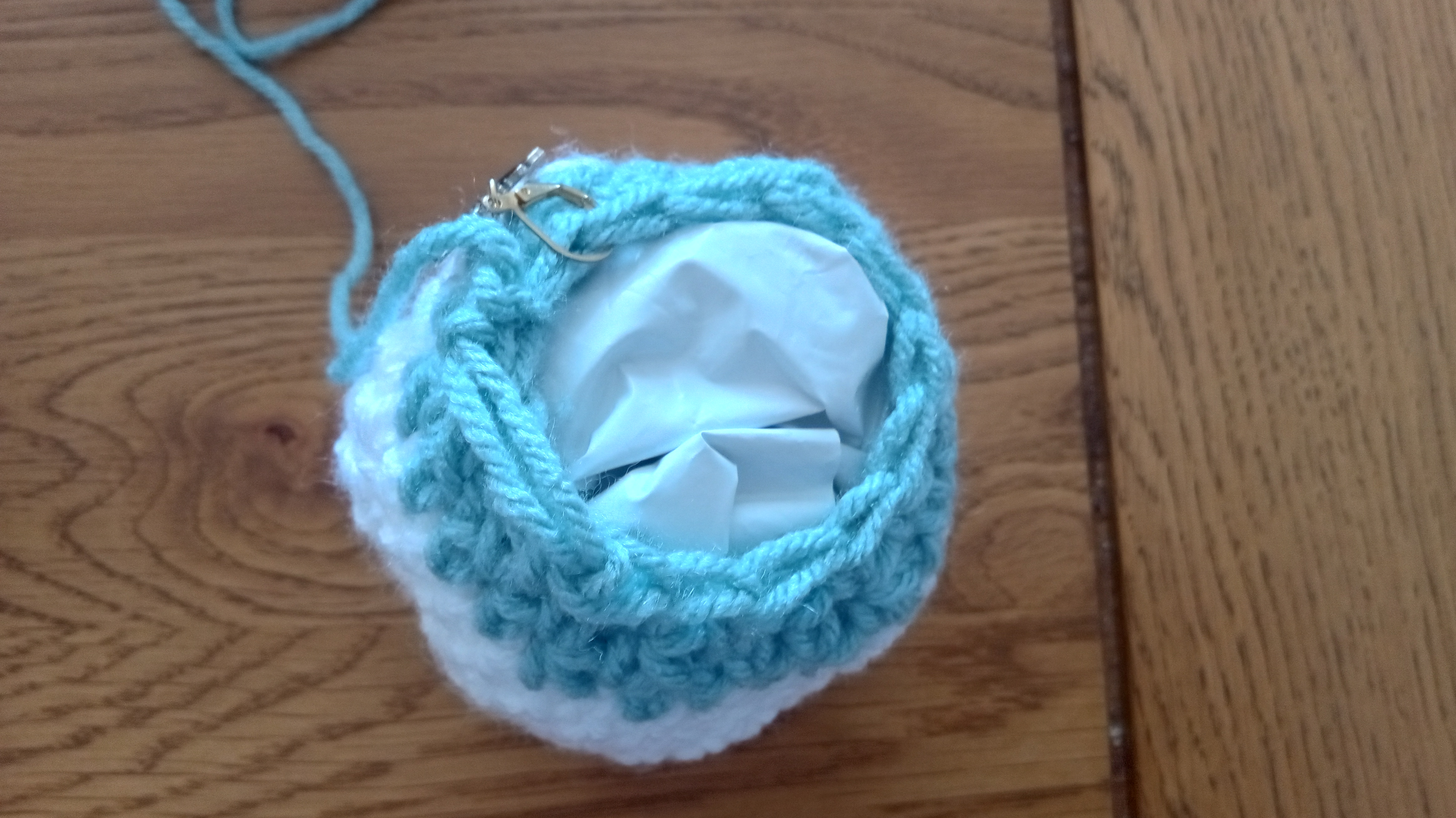 Top-down view of the open top of the planet, it's lightly stuffed with plastic bag scraps